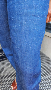 Close-up of blue denim fabric with a textured background