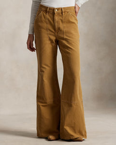 Brown bell-bottom pants worn by a person on a neutral background